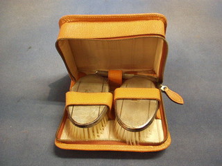 A pair of silver backed military hair brushes and a comb, cased