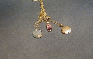 A silver chain hung a glass pendant, ditto hung a Victorian coin and a chain hung a locket