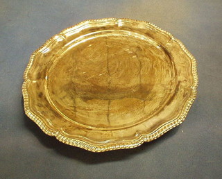 A large circular silver plated salver with bracketed border 14"