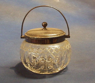 A cut glass biscuit barrel with silver plated mounts