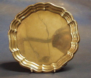 A silver salver with bracketed border, raised on 3 panel supports 8", London 1945, 14 ozs