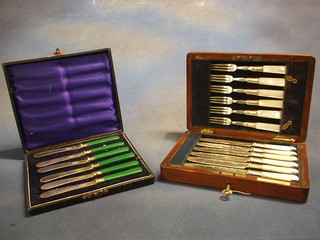 A set of 6 fruit knives with mother of pearl handles in an oak canteen box and a set of 6 fruit knives