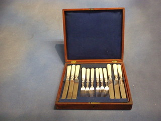 A set of 12 Victorian fruit knives and forks with mother of pearl handles contained in a walnutwood canteen box