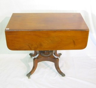 A Georgian mahogany pedestal Pembroke table fitted a frieze drawer and raised on turned columns with triform base and splayed feet  36"