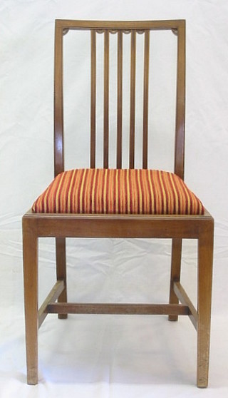 A set of 6 Edwardian mahogany stick and rail back dining chairs with upholstered seats, raised on square tapering supports