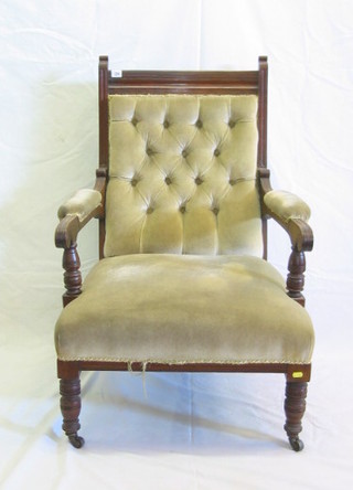 A Victorian walnutwood open arm chair, upholstered buttoned material, on turned supports