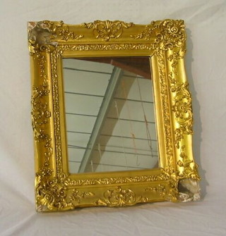 A rectangular plate mirror contained in a decorative gilt frame 23"