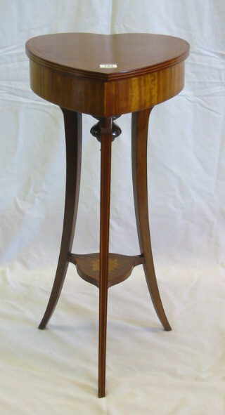 An Edwardian bleached mahogany heart shaped sewing box with hinged lid, raised on outswept supports with undertier 14"