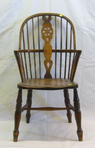 An elm stick and wheel back Windsor chair on turned supports