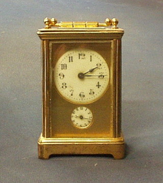 A 19th Century French carriage alarm clock with circular porcelain dial with Arabic numerals and alarm dial, contained in a gilt metal case 4 1/2" (bell missing)