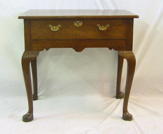An 18th Century honey oak low boy with brass plate drop handles, raised on club supports 30"