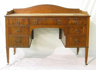 A Victorian walnutwood dressing table with three-quarter gallery, fitted 1 long drawer flanked by 6 short drawers raised on square tapering supports 48"