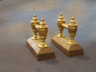 A pair of iron and brass fire dogs