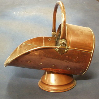 A copper helmet shaped coal scuttle