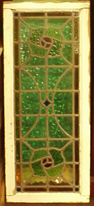 A 1930's stained glass panel contained in a white painted frame 39" x 16"