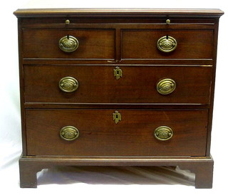 A Georgian mahogany chest fitted a brushing slide and 2 short and 2 long drawers, raised on bracket feet, 35"