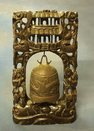 An Eastern metal tea bell, hung on a pierced hardwood stand