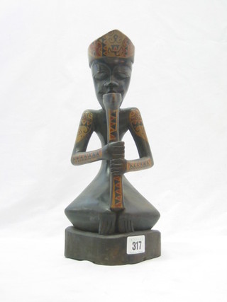 A carved African figure of a musician 12"