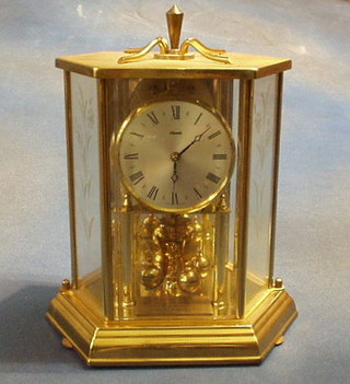 A 400 day clock contained in a gilt lozenge shaped glass case