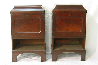 A pair of mahogany pedestal cabinets enclosed by panelled doors and raised on bracket feet 18"