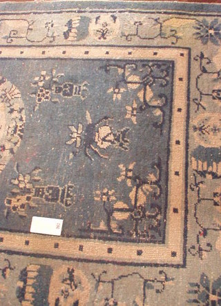 A 1930's Hong Kong blue ground and floral patterned Chinese rug 76" x 51"