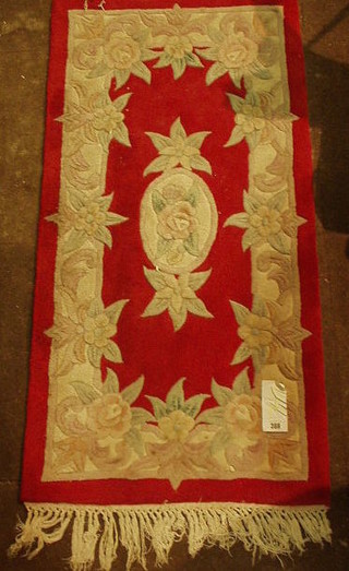 A contemporary red ground Chinese rug 47" x 23"