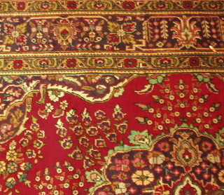 A contemporary Persian Tabriz carpet with central medallion within multi row borders 119" x 78"