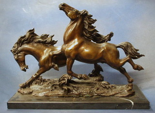 A modern bronze figure of 2 running horses, raised on a marble base 20"