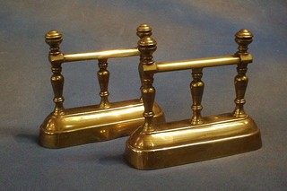 A pair of 19th Century brass fire dogs