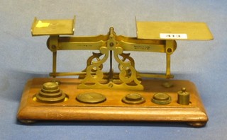 A pair of 19th Century brass and wooden letter scales by Windle & Blyth complete with weights