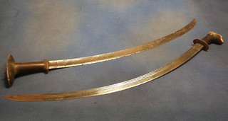 A pair of crescent shaped swords with horn handles, the blade with double headed eagle