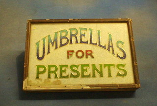 A glass advertising sign "Umbrellas For Presents" 9" x 13"