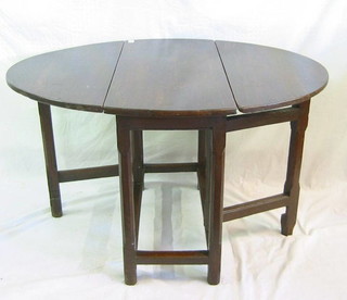 An 18th Century oak oval drop flap gateleg dining table raised on square chamfered supports united by a stretcher 32"