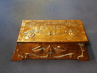 An Art Nouveau embossed copper cigarette box raised on bracket feet 10 1/2"