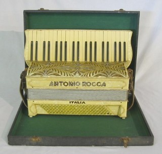 An Alvari accordion with 24 buttons contained in a fibre carrying case