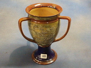 A Royal Doulton 3 handled loving cup, marked Gerald John Darwood 1886 - 1907, 11th July, To Gerald From Hugh and Carrie Richards, the base impressed Royal Doulton 6860, 11" (1 handle r)