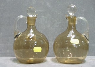 A pair of brown glass ewers with clear glass handles and stoppers 8"