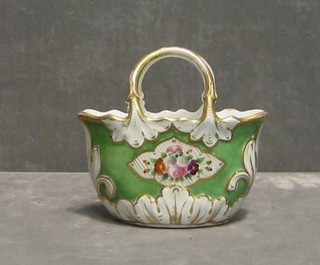 A 19th Century porcelain vase in the form of a green glazed basket with decorative floral painted panels 5"
