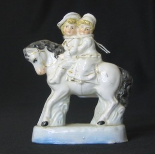 A pair of 19th Century porcelain figures of children on horse back 5"