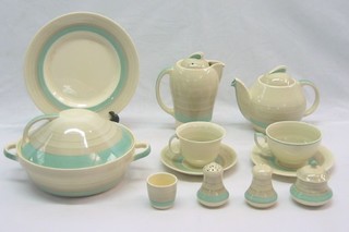 A Susie Cooper 66 piece dinner service comprising: 3 graduated pottery meat dishes, 2 vegetable tureens and covers, sauce boat, twin handled sauce tureen, 6 dinner plates (3 cracked), 6 side plates (2 cracked), 6 tea plates 1 cracked, circular tea plate, 6 egg cups, teapot, hot water jug (crazed), sugar bowl, preserve jar and cover (lid cracked), 3 piece condiment set - salt, pepper and mustard pot (lid cracked), butter dish and lid (slight chip to inner rim), 7 large saucers (1 cracked), 3 large cups, sugar bowl, 4 saucers 6 cups, (3 cracked)