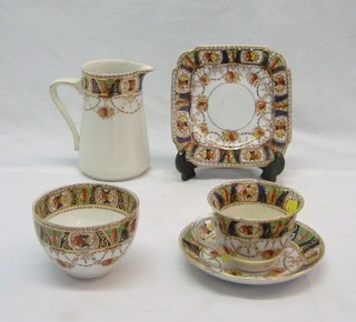A Derby style 30 piece tea service by Burgess comprising: pottery jug, twin handled rectangular sandwich dish, twin handled bread plate, 13 square sandwich dishes, 9 saucers, 5 cups and a sugar bowl