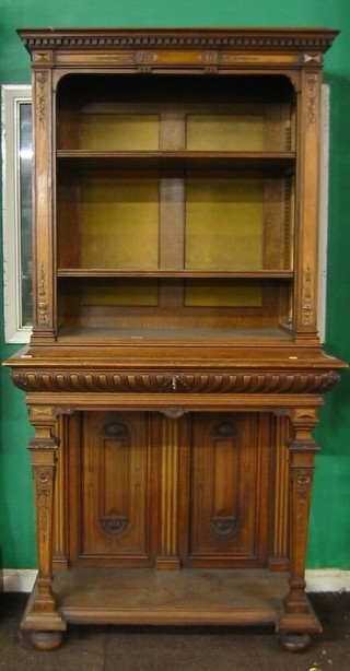 A 19th Century Italian carved walnutwood bookcase on stand with moulded and dentil cornice, the interior fitted shelves, the base fitted 1 drawer above a recess, raised on square tapering supports 42"