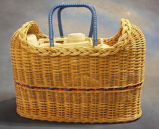 A  1950's plastic picnic set contained in a basketware holdall