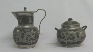 A black Tanware hotwater jug and matching sugar bowl with pewter decoration