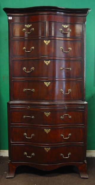 A good quality Georgian style, serpentine fronted, mahogany chest on chest with moulded cornice and blind fret work canted corners, the upper section fitted 2 short and 3 long drawers, the base fitted a brushing side above 3 long drawers, raised on ogee bracket feet 36"