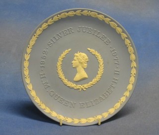 A Wedgwood blue Jasperware 1973 Christmas plate, a 1976 do., a 1977 Silver Jubilee plate and a circular Jasperware plate