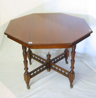 A Victorian octagonal walnutwood occasional table raised on turned and block supports with X framed bobbin turned stretcher 36"