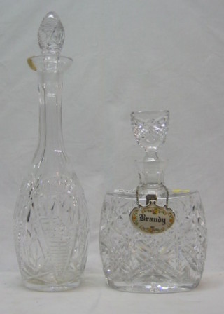 A cut glass spirit decanter with porcelain brandy label and a club shaped decanter