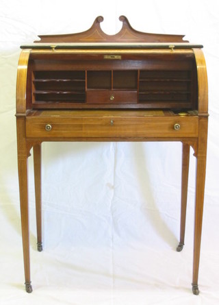 An Edwardian inlaid mahogany cylinder bureau with broken pediment to the back, the cylinder fall revealing a well fitted interior with pigeon holes, the base fitted 1 long drawer and raised on square tapering supports 29"