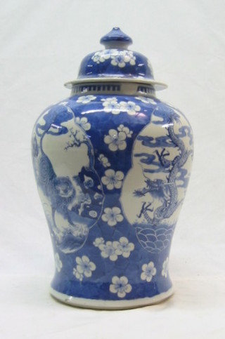 A 19th Century Oriental blue and white urn and cover (f and r) 16"